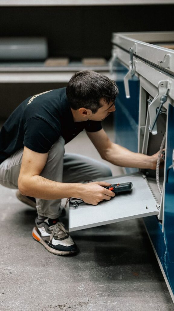 Crafting Captivating Headlines: Your awesome post title goes here A focused technician inspects machinery indoors, ensuring operational efficiency.